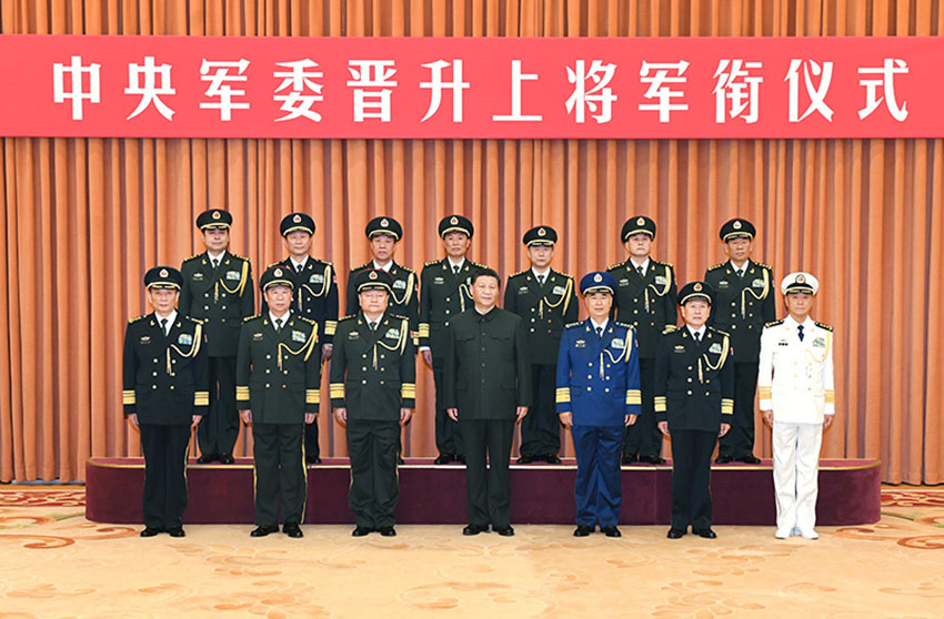 12月12日，中央軍委晉升上將軍銜儀式在北京八一大樓隆重舉行。中央軍委主席習(xí)近平向晉升上將軍銜的軍官頒發(fā)命令狀。這是習(xí)近平等領(lǐng)導(dǎo)同志同晉升上將軍銜的軍官合影。 新華社記者 李剛 攝